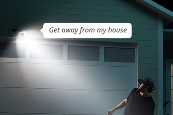 wired floodlight security camera installed by smarter homes australia is shining a light on an intruder to keep the home safe