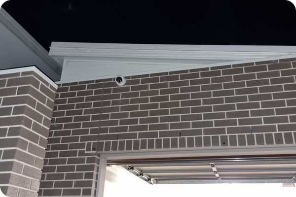 a home security camera installed by smarter homes australia above a garage on a home in brisbane