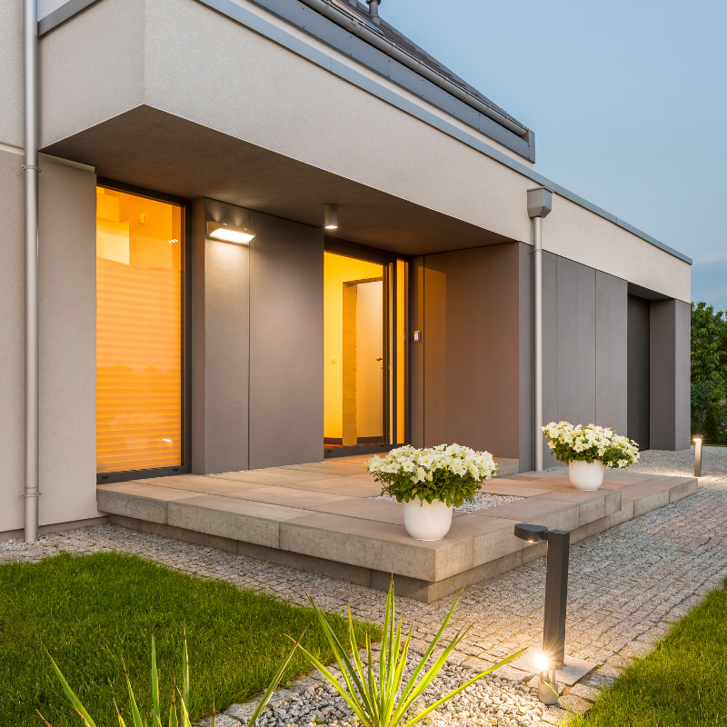 modern house at night with indoor smart lighting installed by Smarter Homes Australia